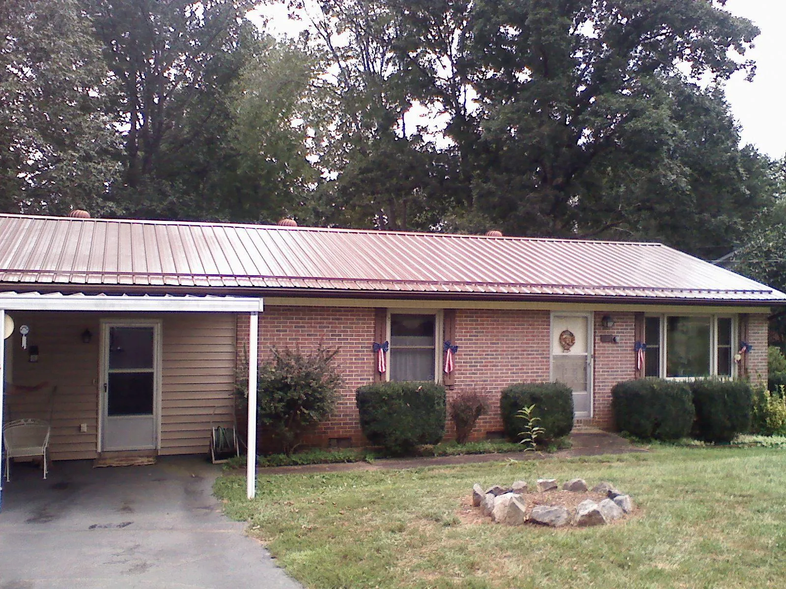 Bronze metal roof and carport on a brick ranch home — Roof Repair work by our crew in Hillsborough
